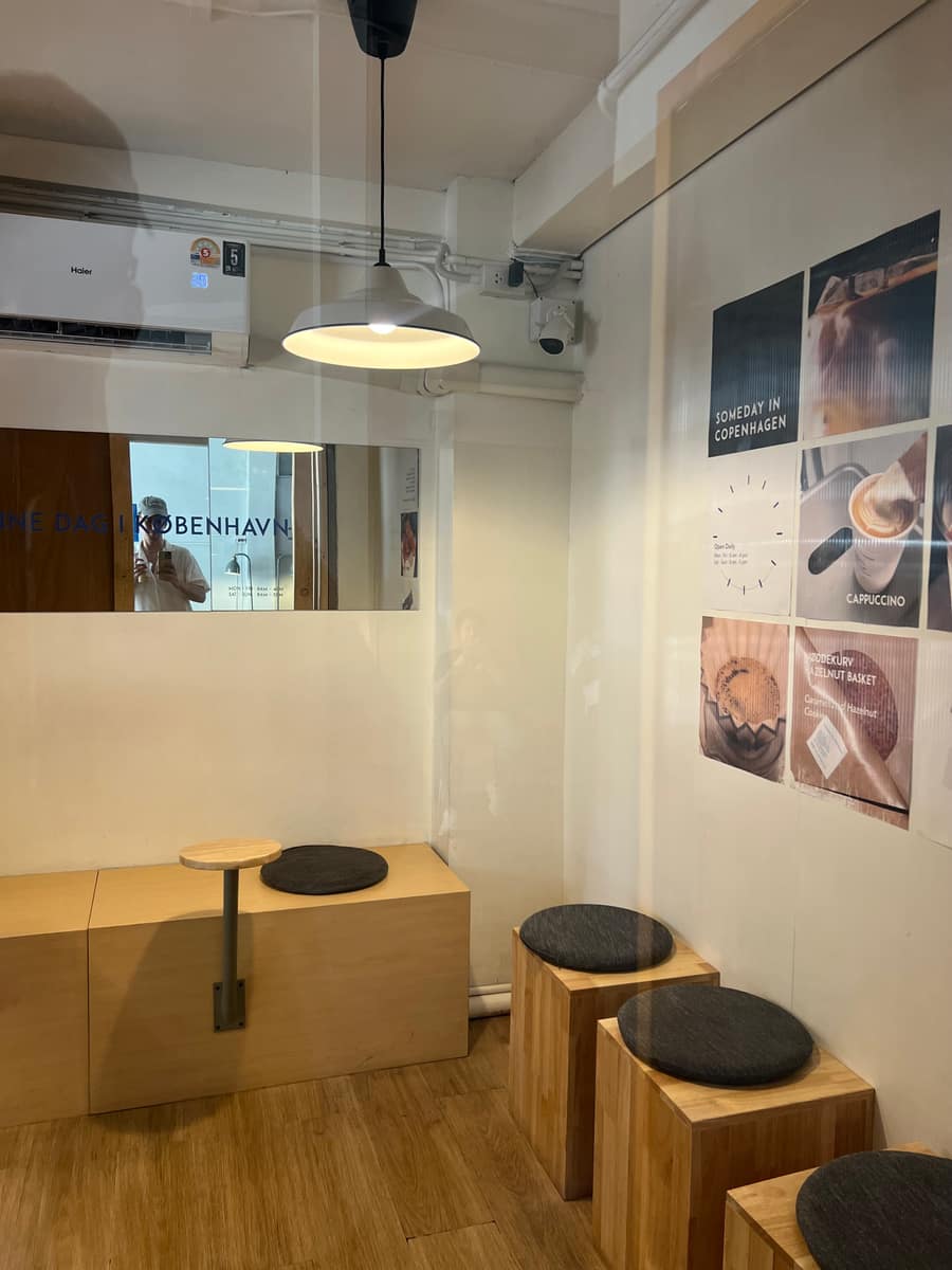 The minimalist Scandinavian interior of Someday in Copenhagen, with wooden stools and menu posters