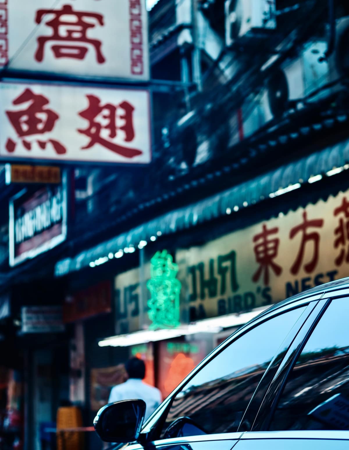 Chinese shop signs stacked above a street in Bangkok's Chinatown