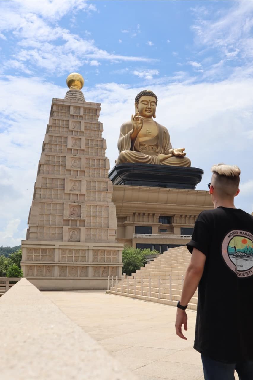 Looking up at the giant golden Buddha and a pagoda at Fo Guang Shan near Kaohsiung