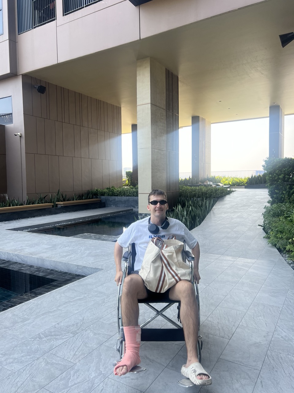 Dave in a wheelchair after spraining his ankle in Bangkok